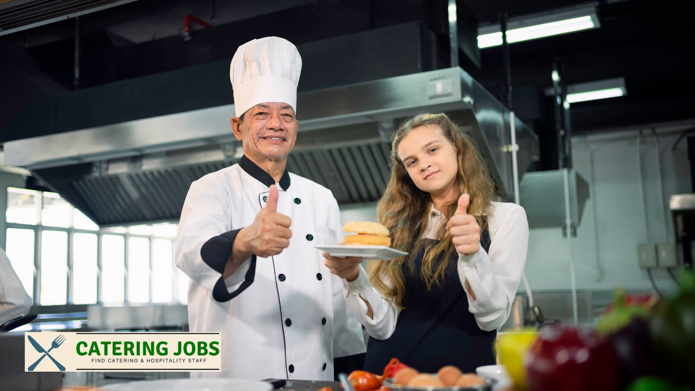 Smiling chef in Team Catering Jobs uniform giving thumbs up